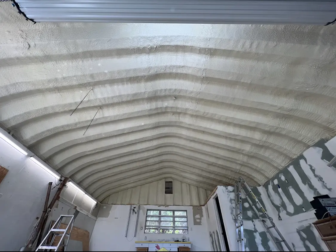 Spray polyurethane foam applied to the underside of a metal roof deck in Dixon